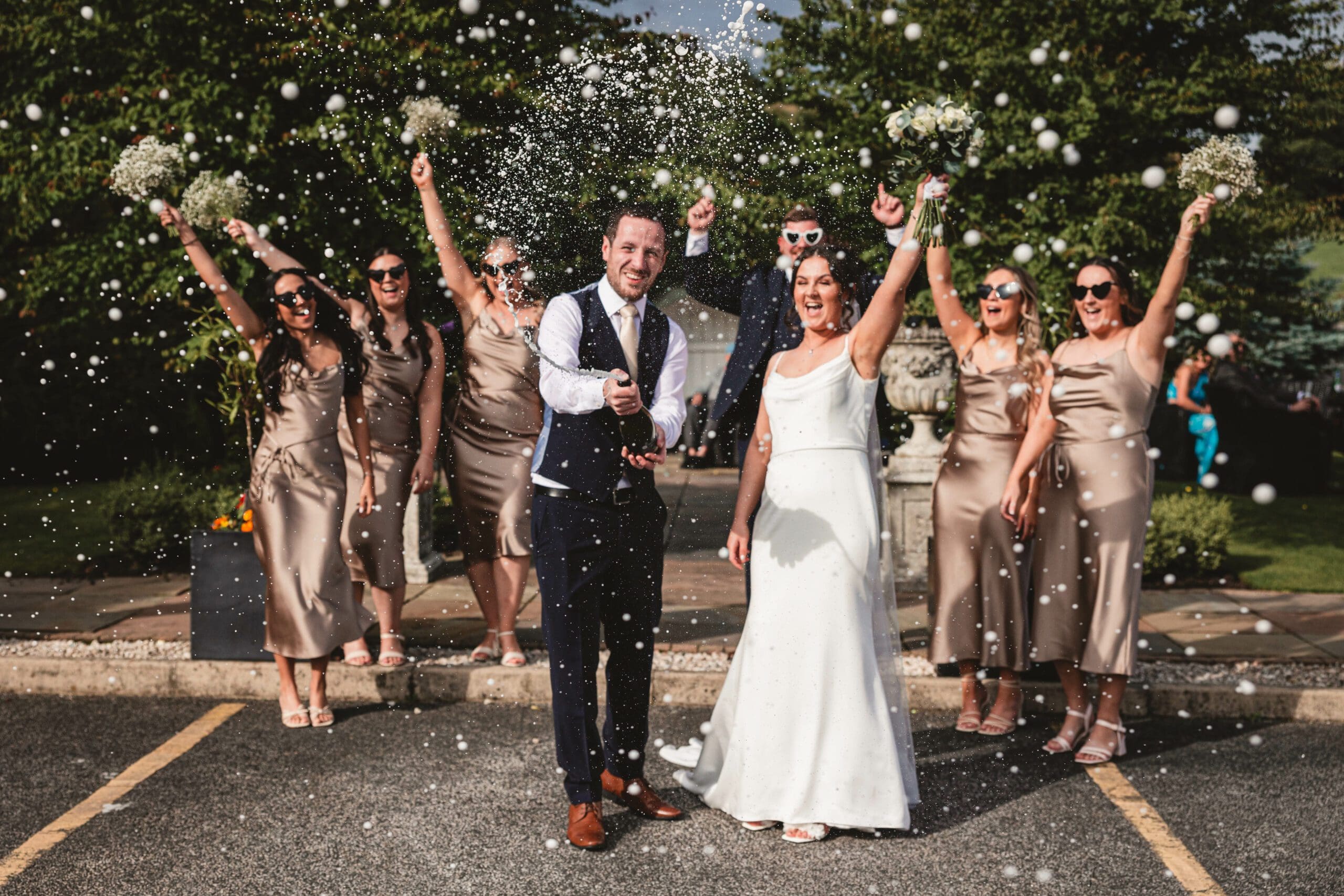 bride and groom spraying champagne at red hall hotel bury